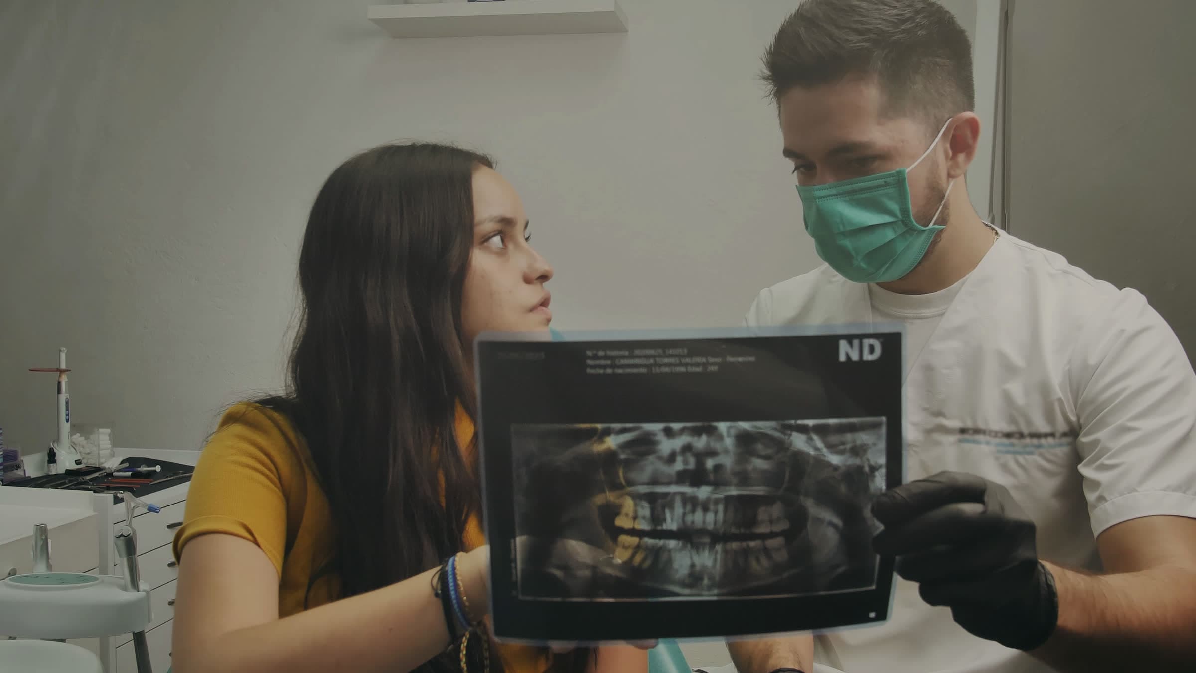 A dentist going through an X-ray with a patient